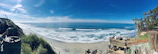 A panoramic beach scene with crystal-clear water and a bright blue sky, taken with a snapgo360 camera.