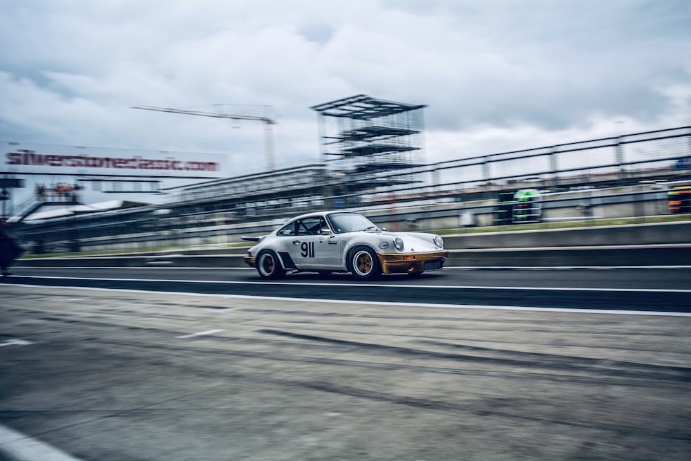 panning photography of white coupe