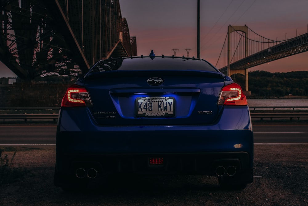 blue Subaru car near bridge