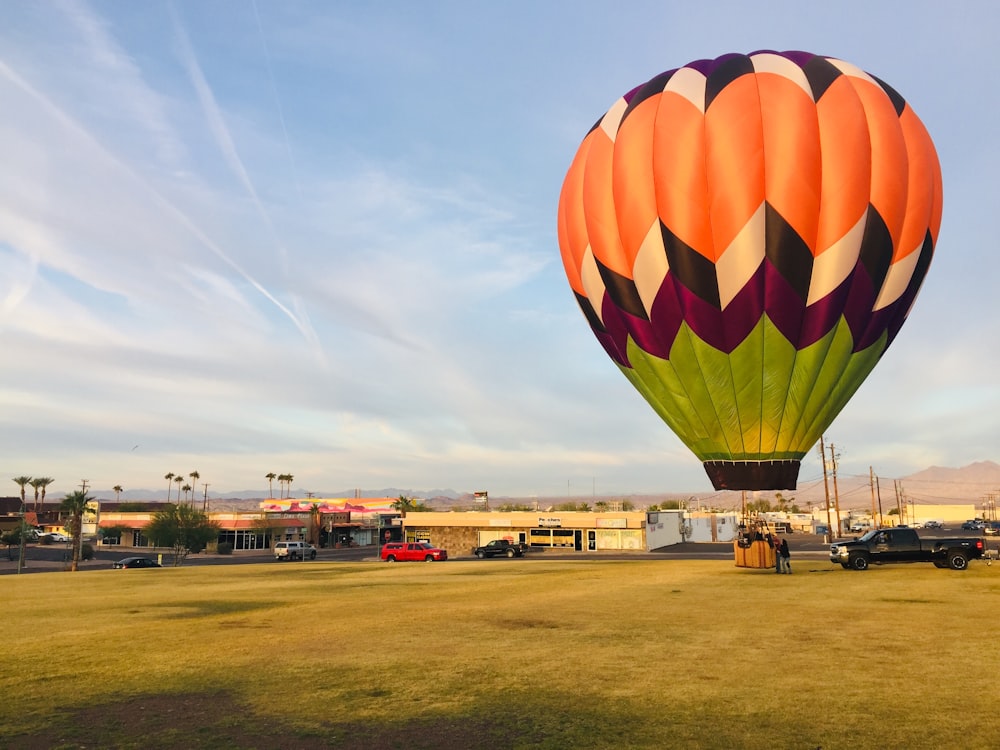 green, maroon, white, and orange hot air balloon