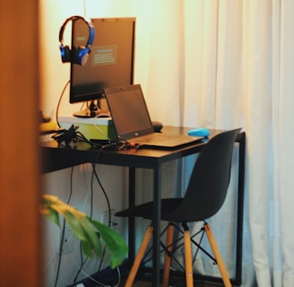 black wooden office table with laptop and monitor