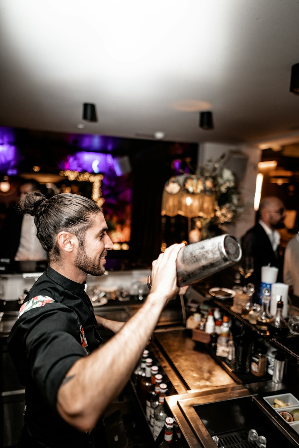 man holding bar shaker inside bar