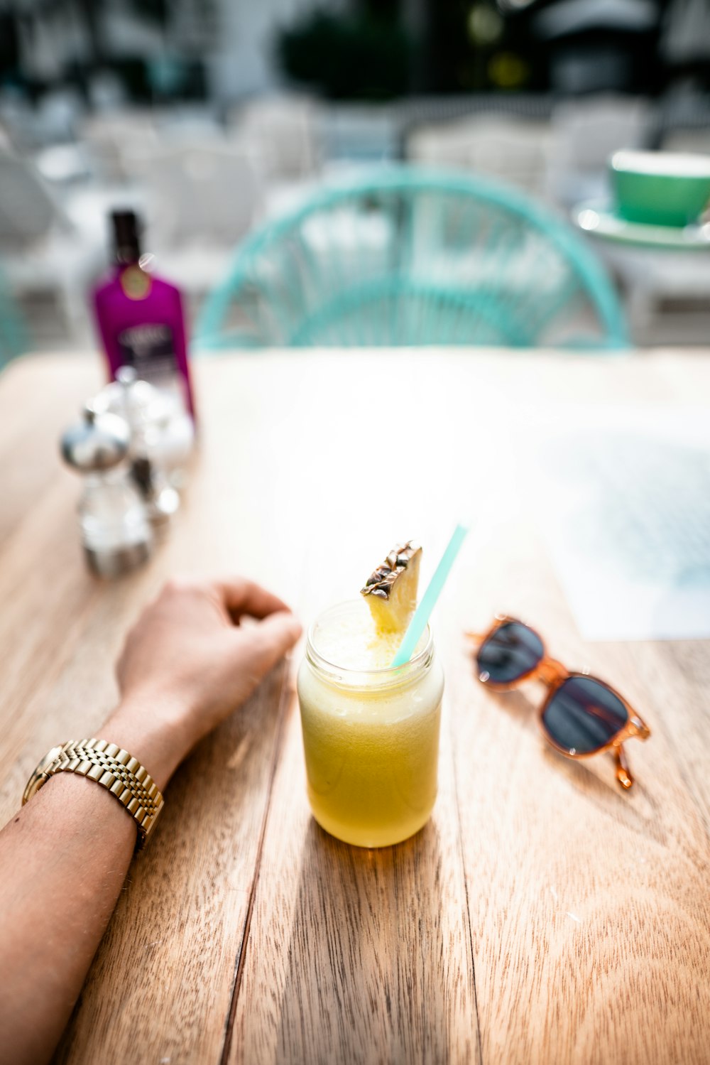 a person sitting at a table with a drink