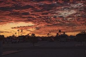 A picturesque sunset with a motorhome silhouetted against the horizon.