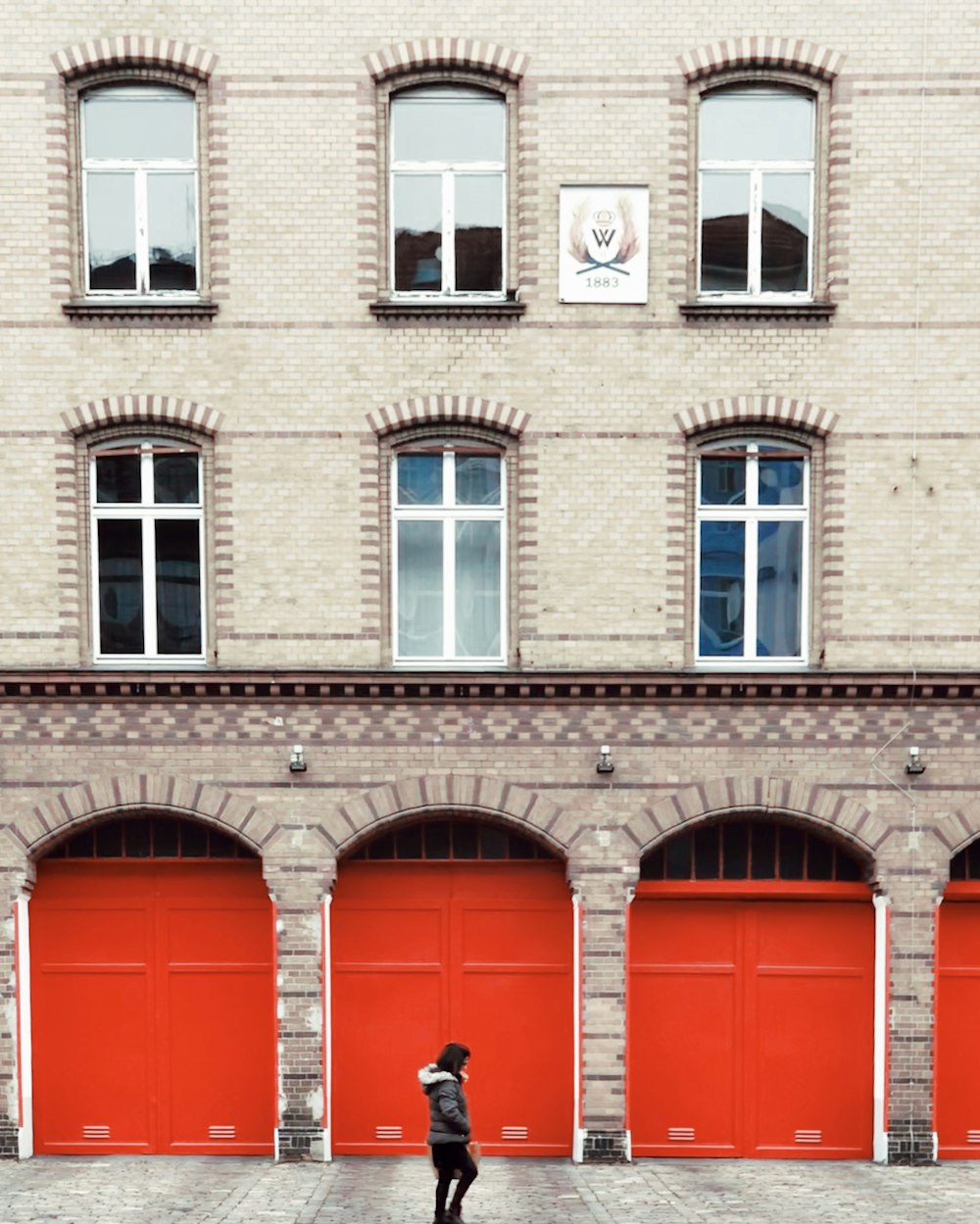 man standing near gray concrete building