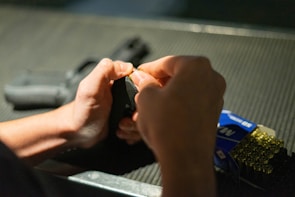 Close-up of hands loading a magazine for dry fire practice.