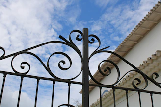 A sturdy, well-crafted entry gate standing tall under a clear blue sky.