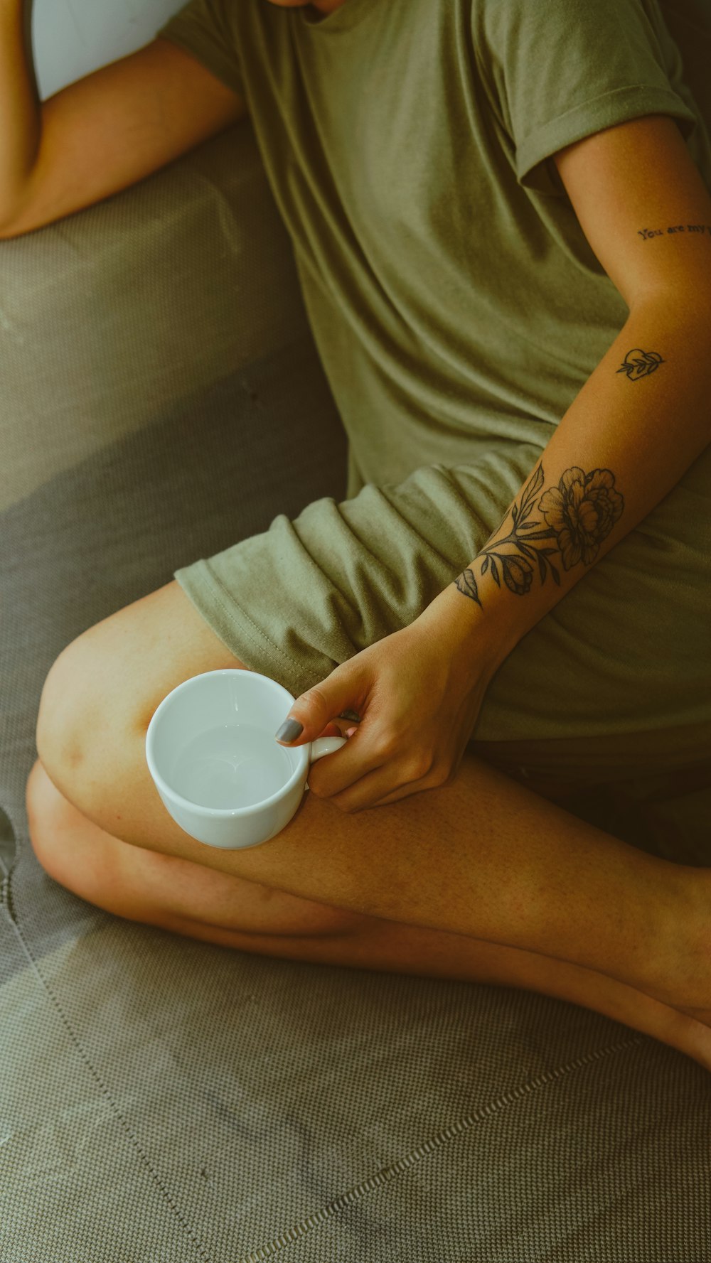 person holding white ceramic cup