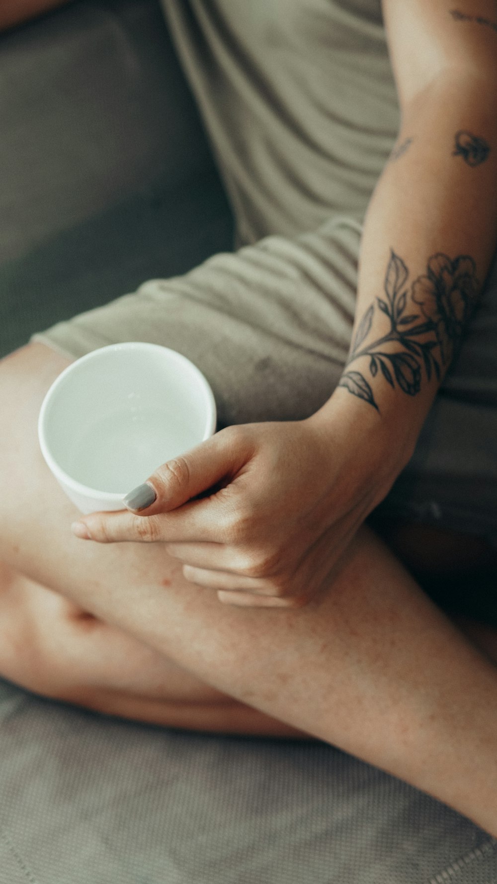 person holding white ceramic cup