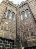 Close-up of intricate heritage building facade highlighting ornate stonework and vintage windows.