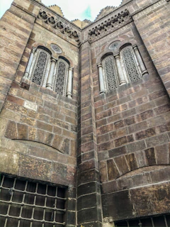 Close-up of intricate mission architecture details, highlighting weathered stone and wooden beams