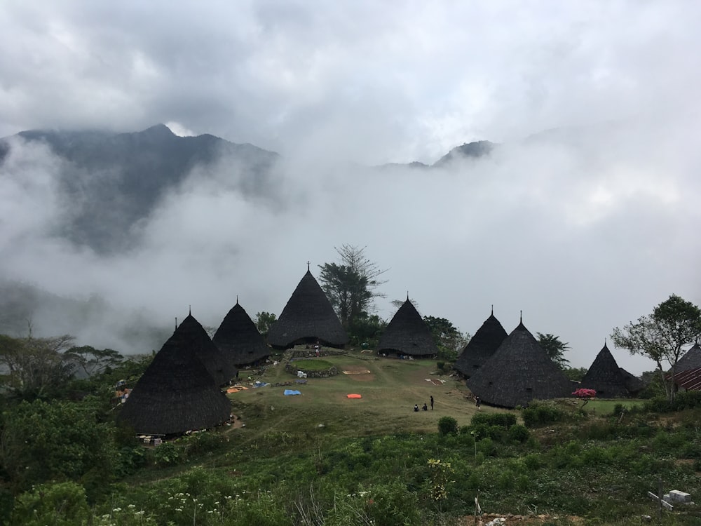 black Nipa huts during daytime
