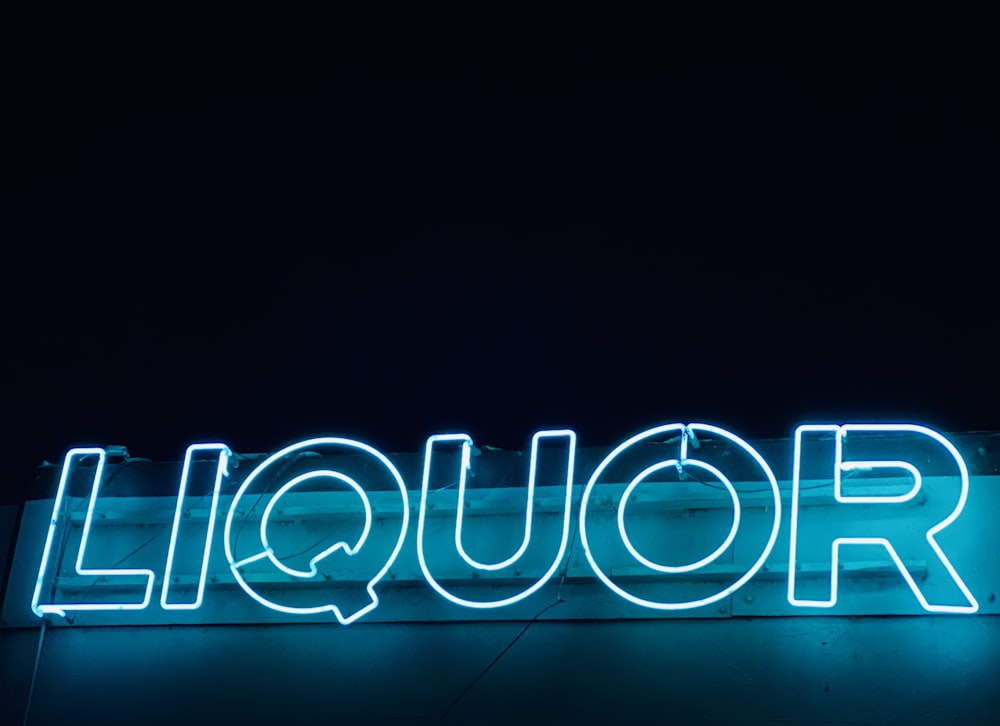 turned on liquor neon signage on building during night