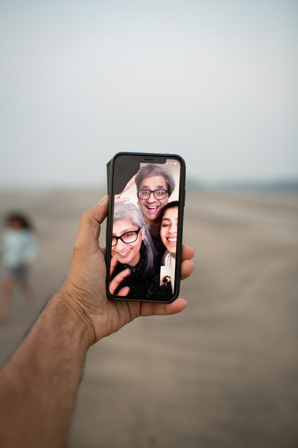 unknown person holding black smartphone