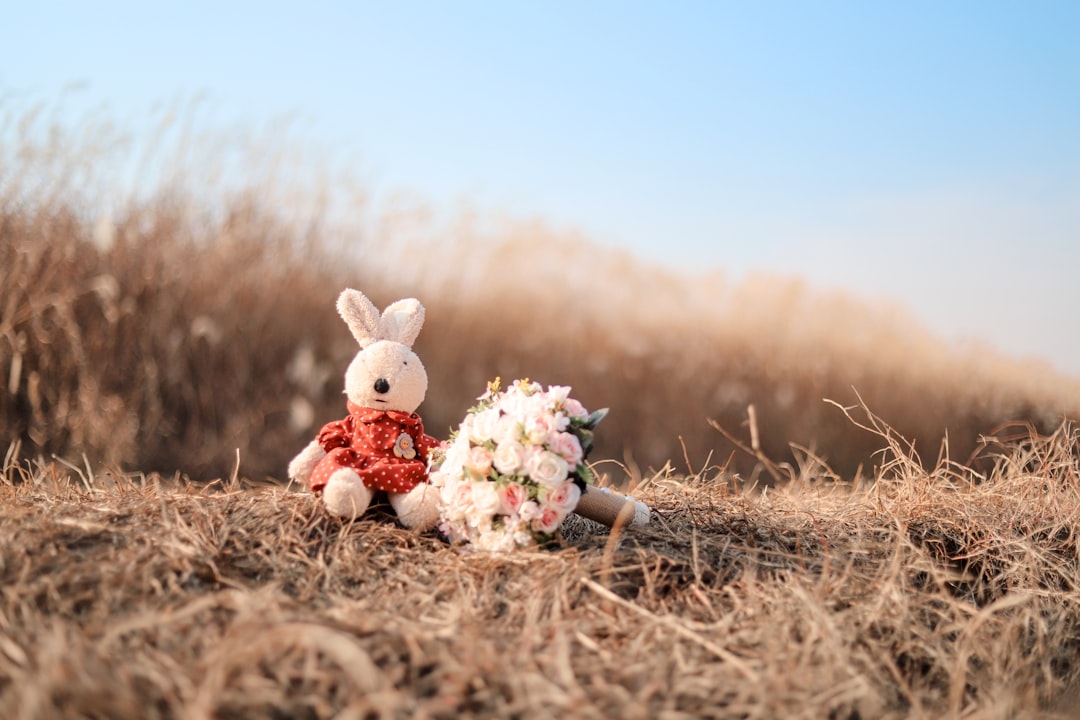 bunny plush toy beside flowers