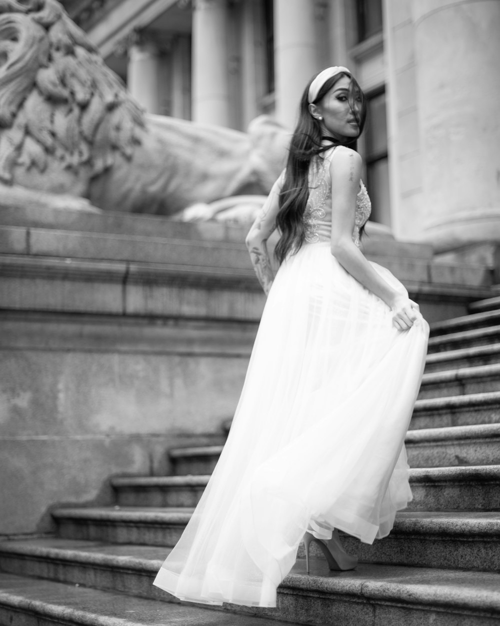 woman walking up the stairs and looking over her right shoulder