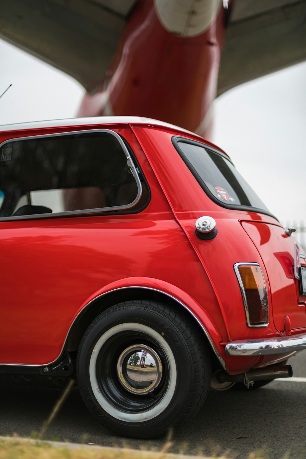 selective focus photography of red hatchback during daytime