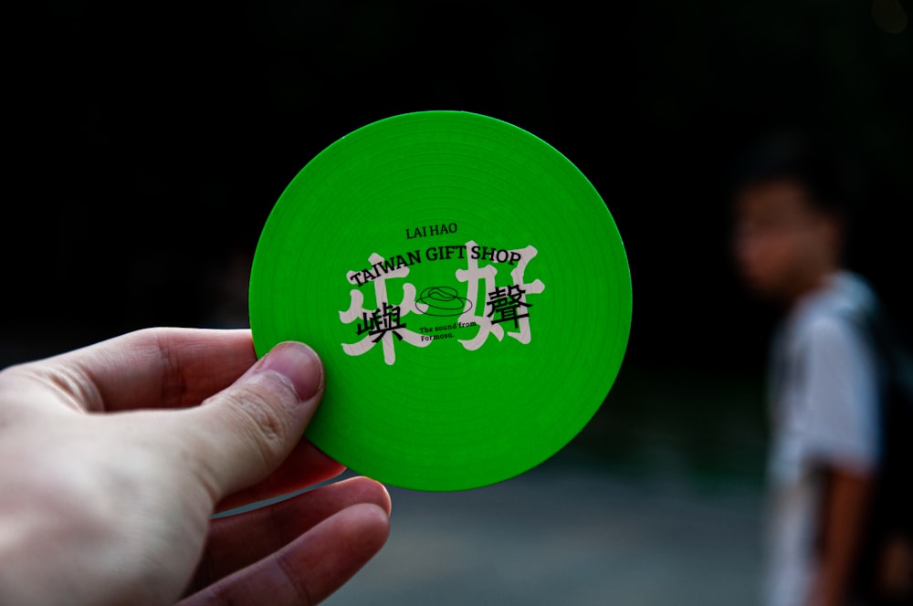 selective focus photography of person holding Taiwan gift shop card