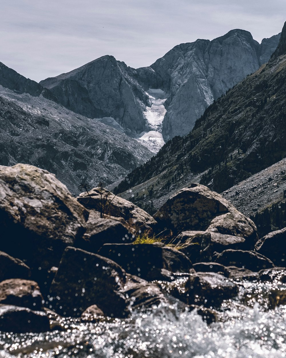 gray rocky mountain under cloudy sky during daytime