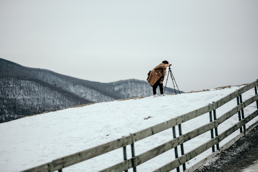 woman standing on hill with camera