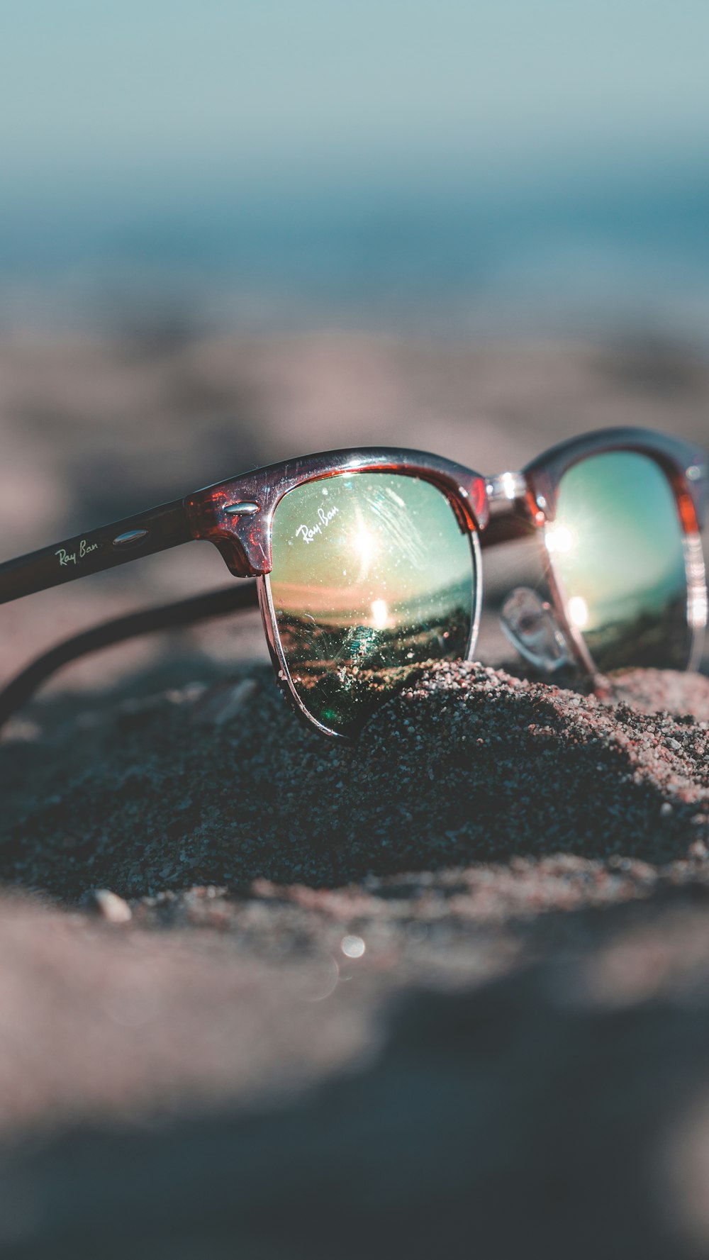 tortoiseshell Ray-Ban Clubmaster sunglasses on sand