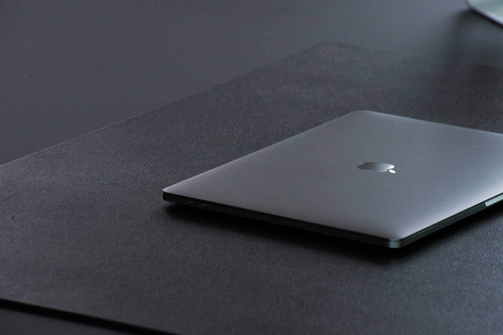 MacBook plateado sobre textil negro
