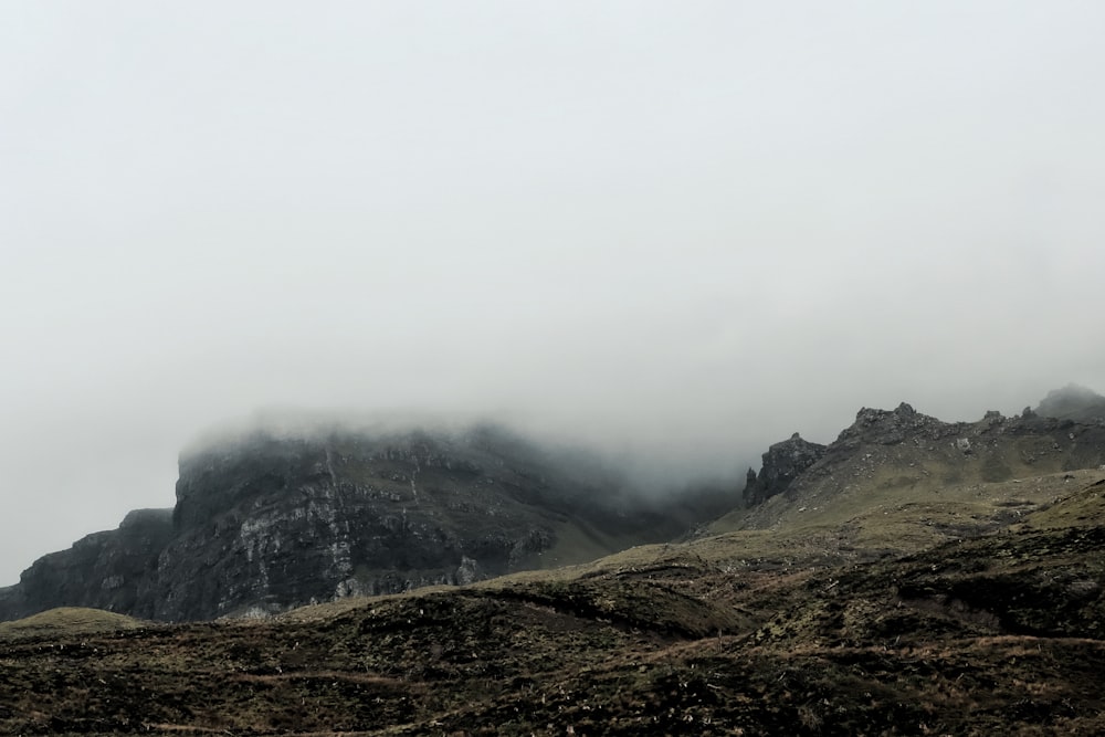 a mountain covered in fog and low lying clouds