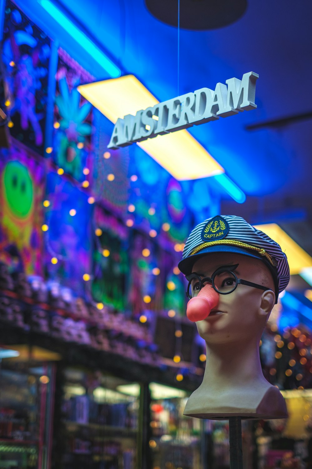 shallow focus photo of mannequin head wearing blue hat