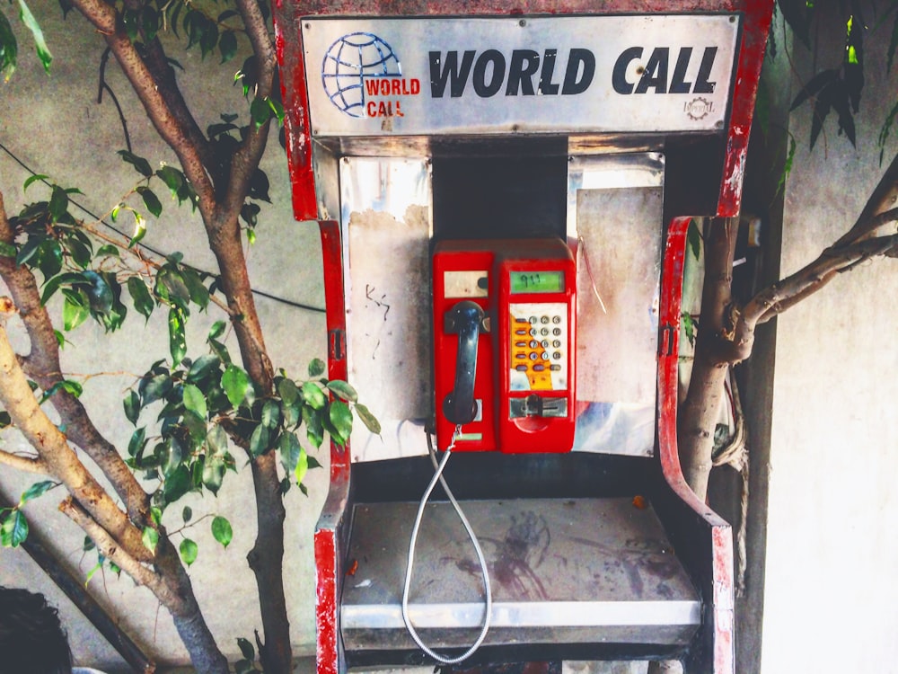 red and black World Call coin-operated telephone