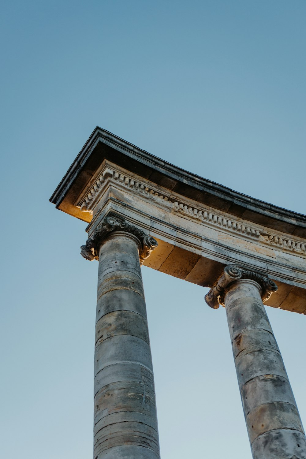 low-angle photography of brown historic column