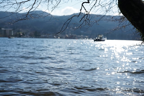 A serene landscape with a boat reflecting in the water.