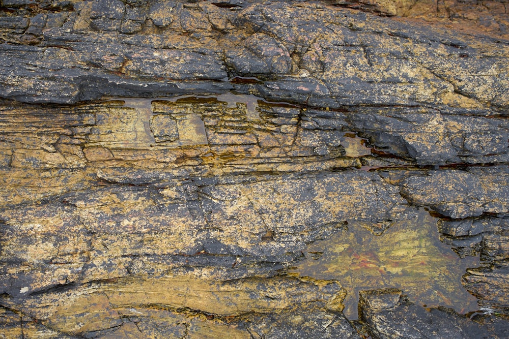 a close up of a rock face with a clock on it