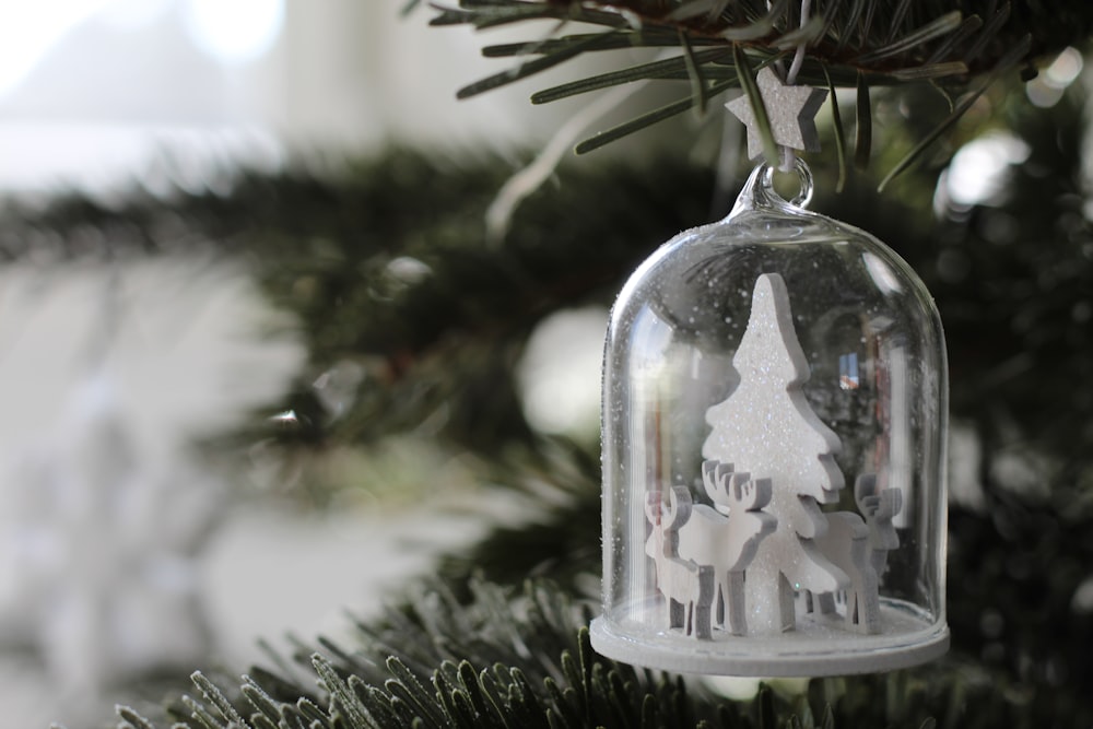 Christmas tree and reindeer in glass dome hanging from Christmas tree