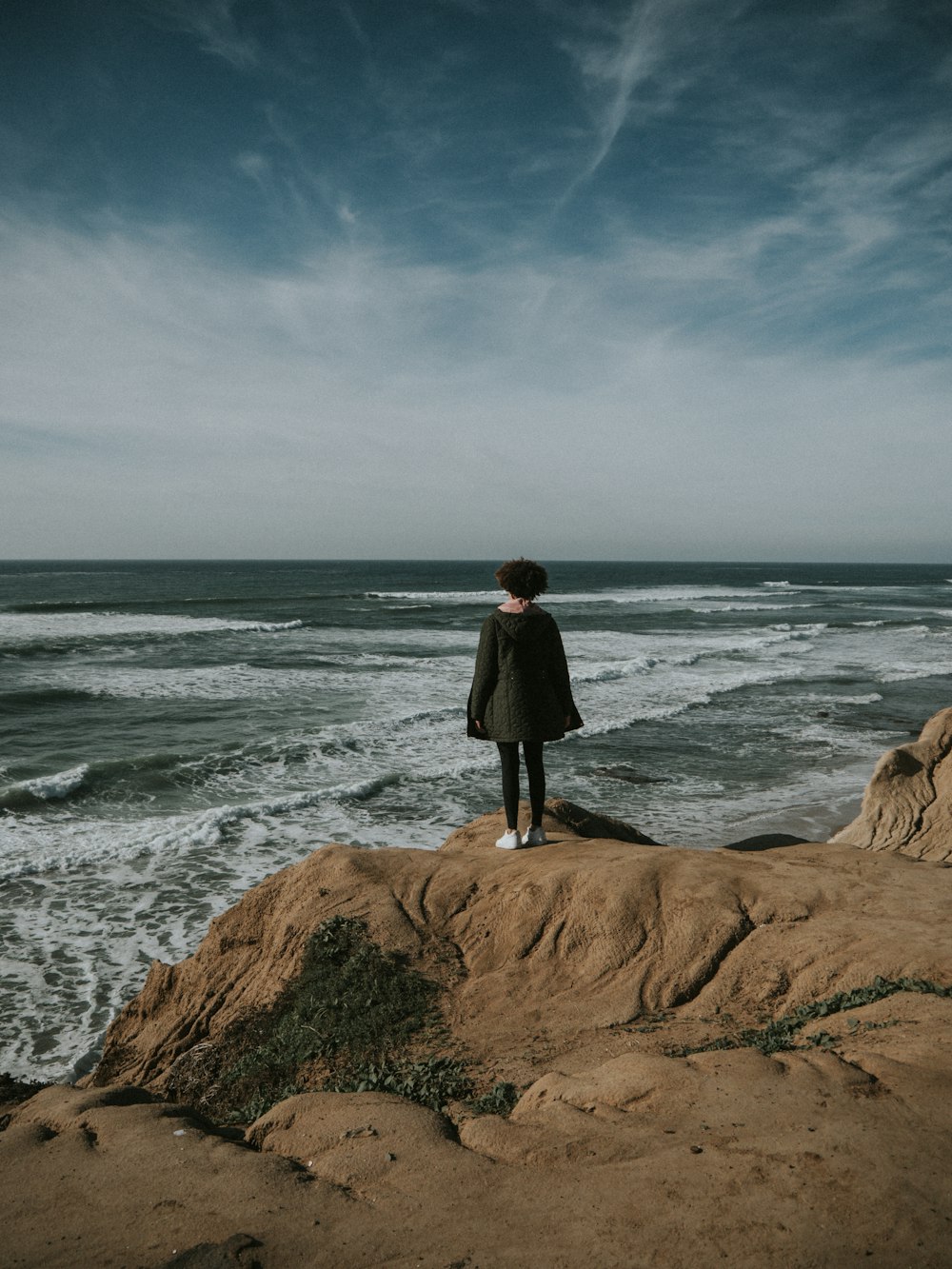 person standing in front of ocean during daytime