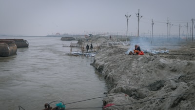 Engineers inspecting flood mitigation structures along a riverbank in Sandakan.