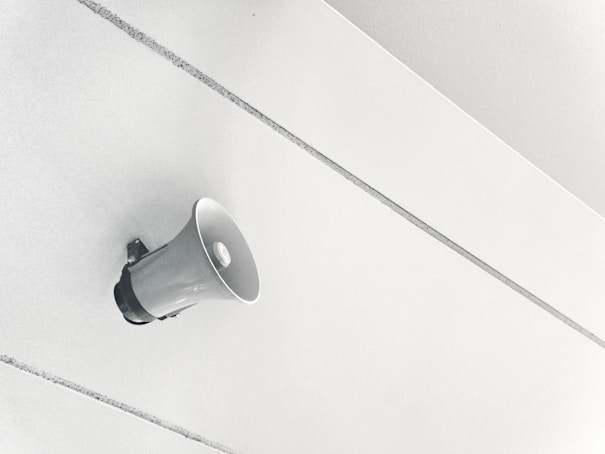 gray megaphone on white surface. Promote. Traffic. Engagement. website traffic