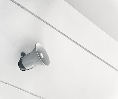 gray megaphone on white surface