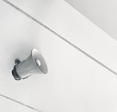 gray megaphone on white surface