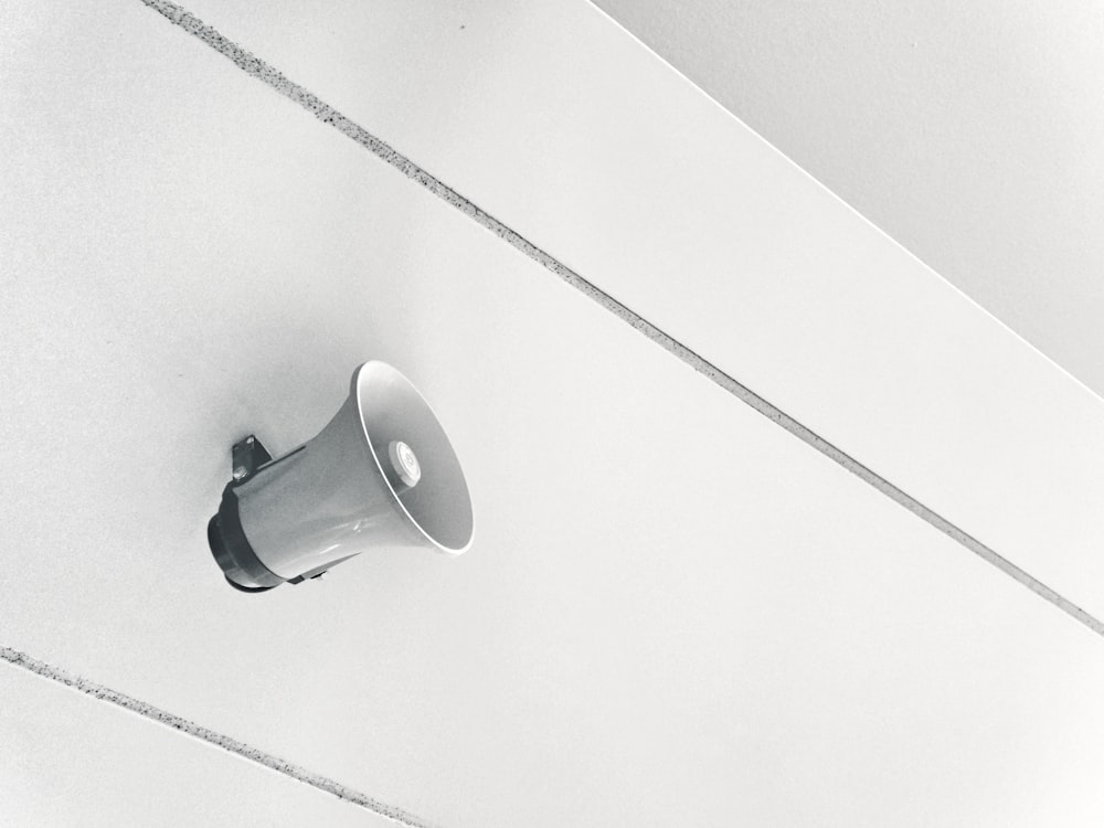 gray megaphone on white surface