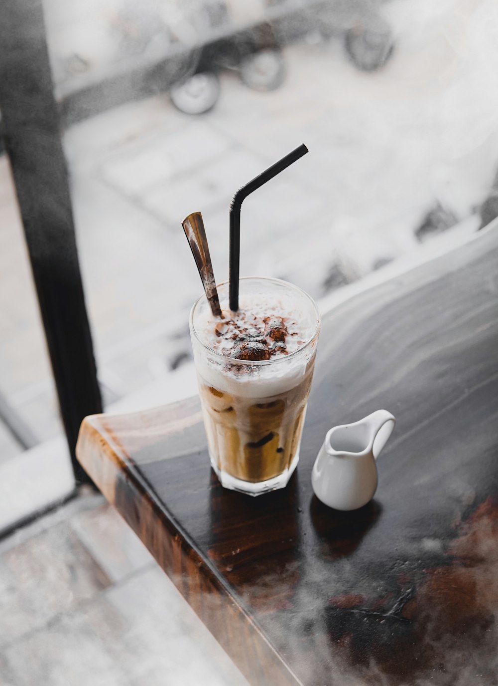 drink with straw on wooden table