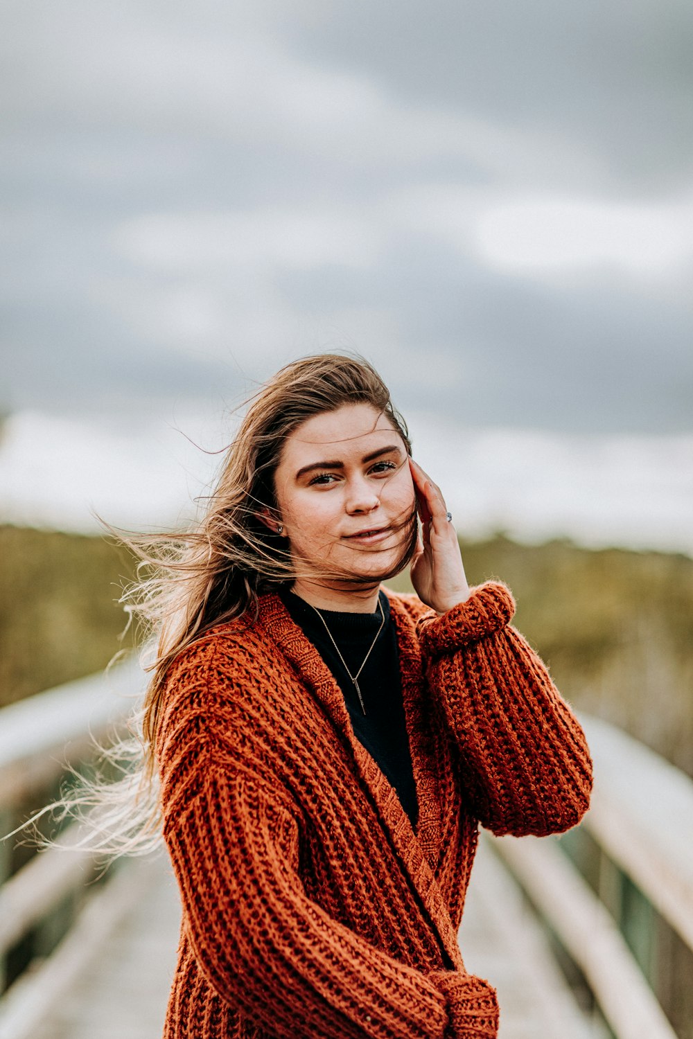 shallow focus photo of woman in brown jacket