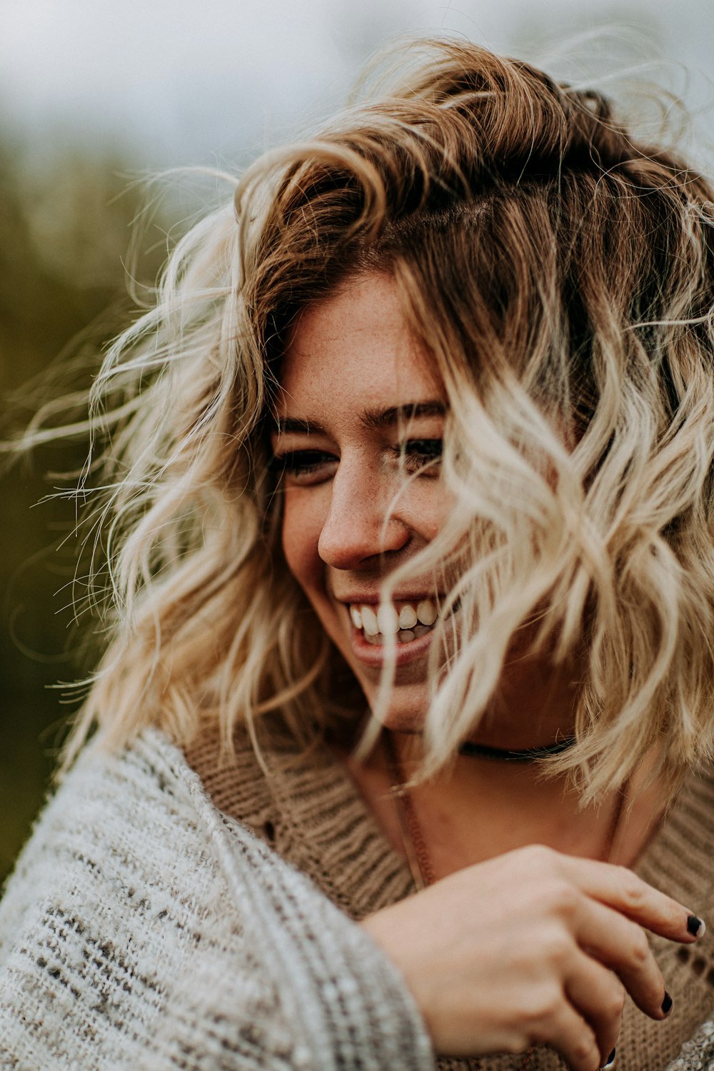 shallow focus photo of woman in brown top