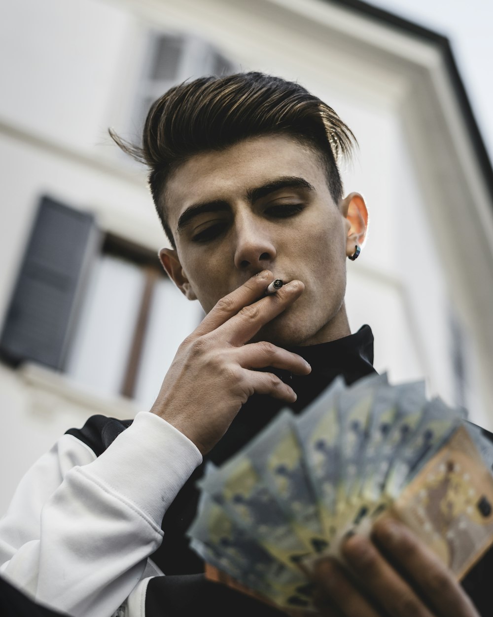 shallow focus photo of man holding banknotes