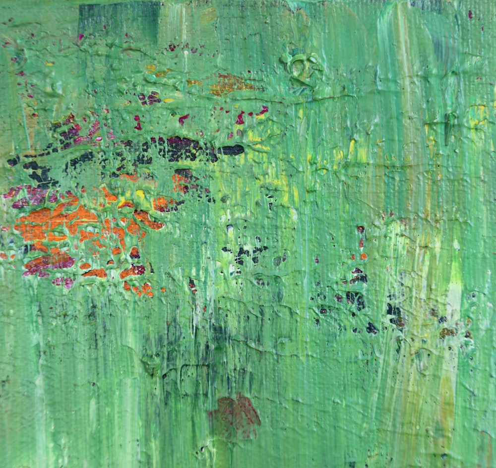 an abstract painting of green and red flowers