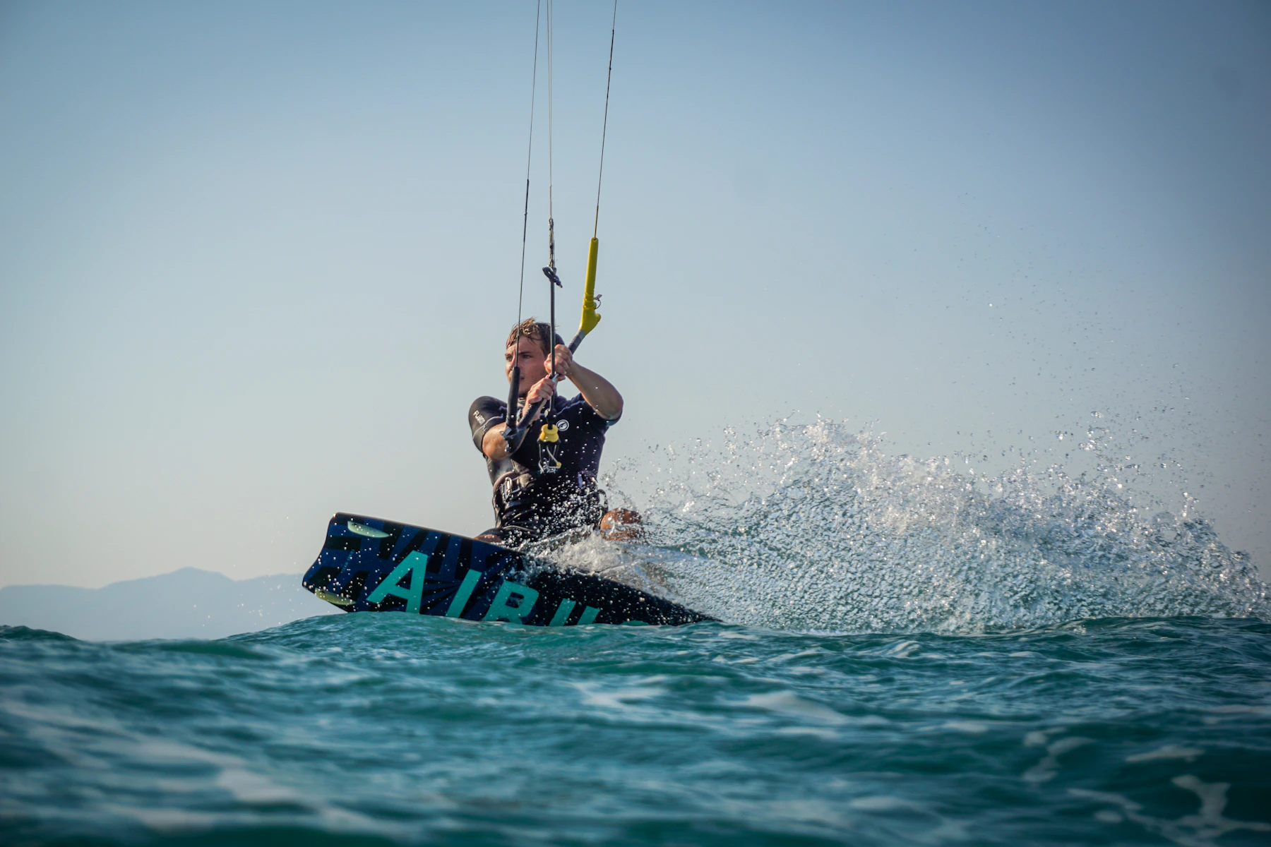 Kiter throwing a wall of spray