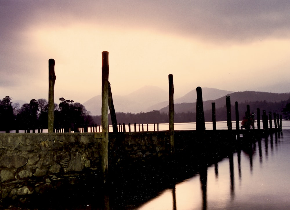 silhouette of bridge under cloudy sky