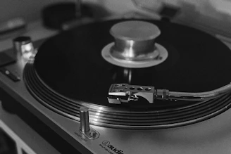 grayscale photography of a turntable