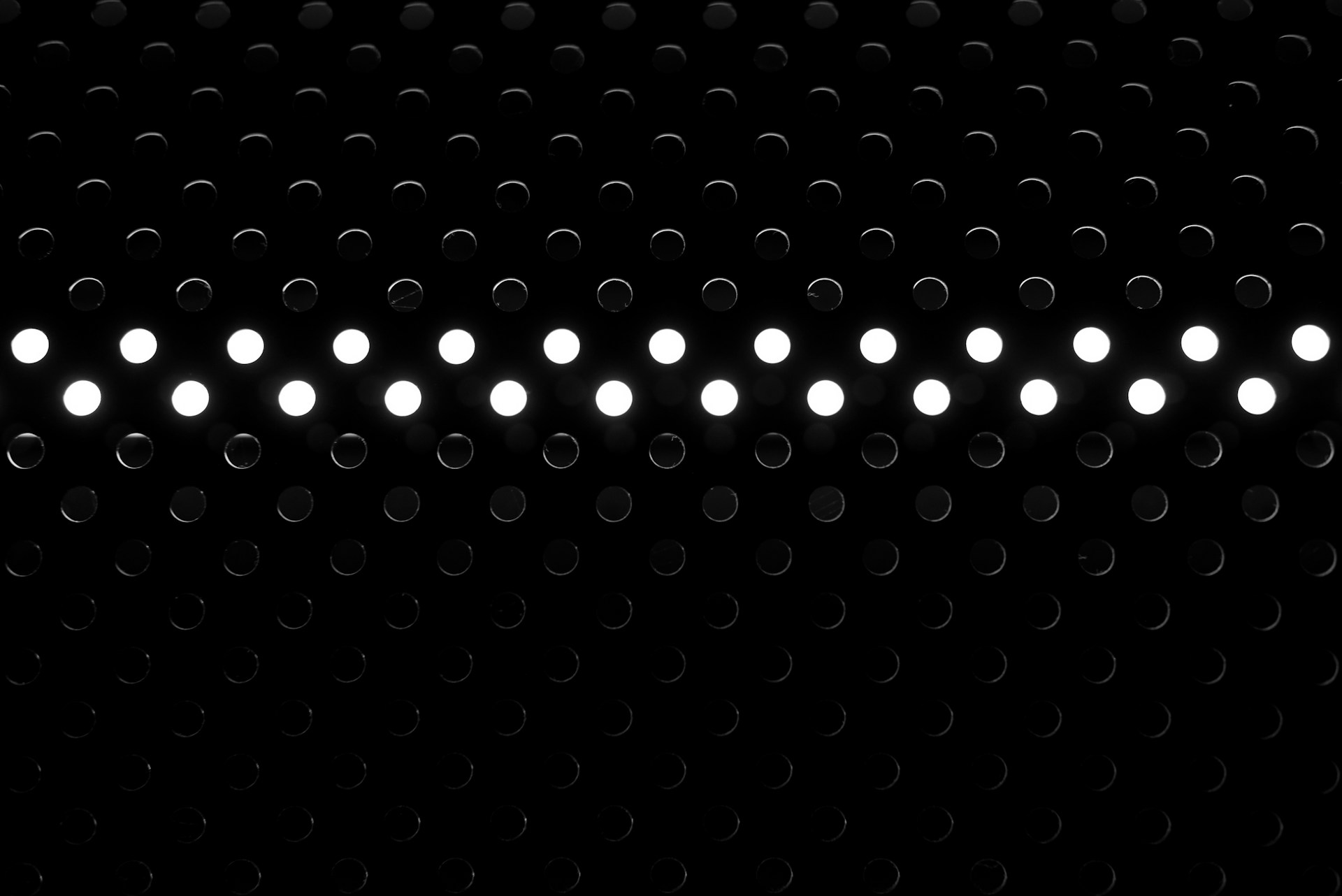 a black and white photo of a row of lights