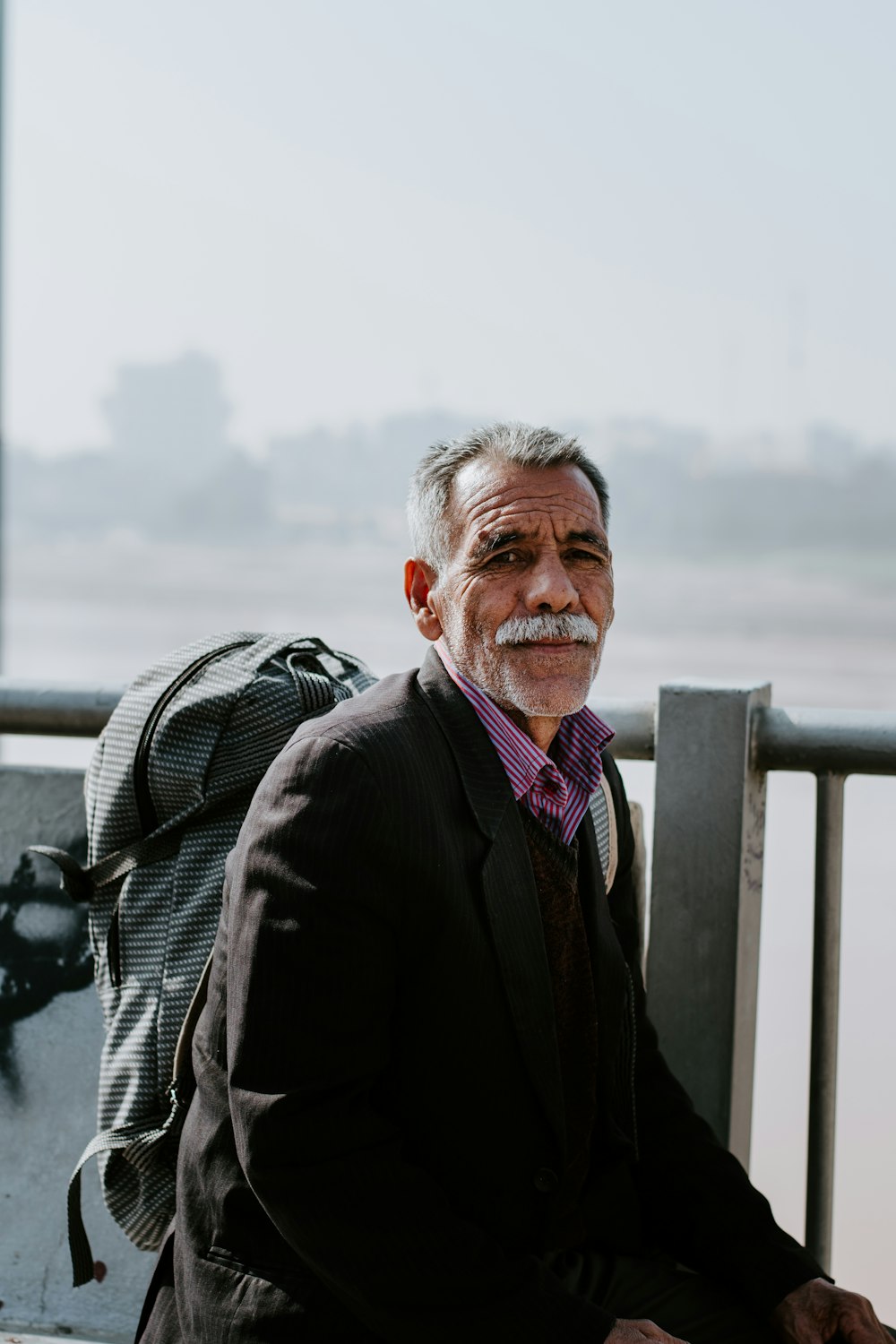 man carrying backpack