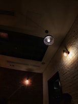 Charming single room with exposed brick walls and soft lighting.